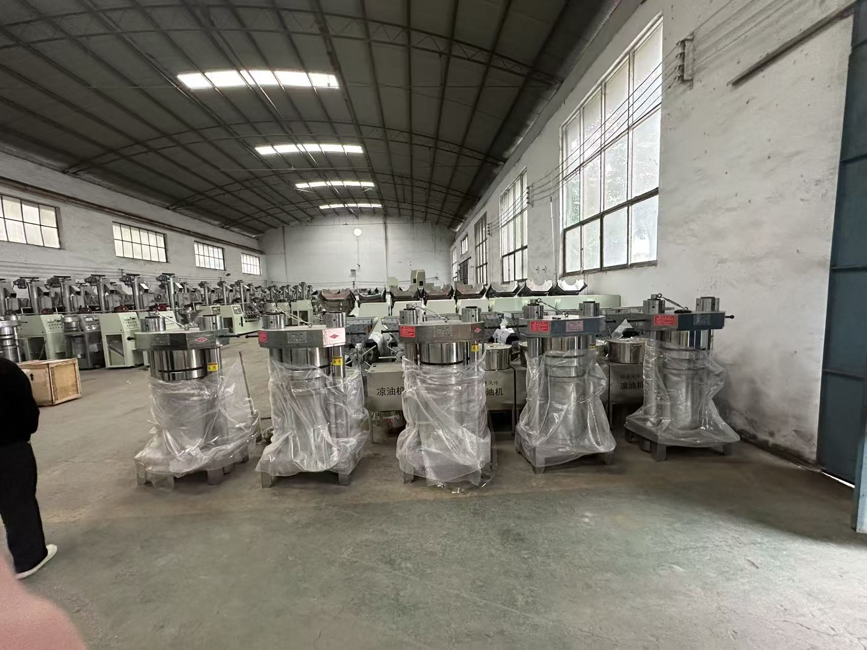 Heavy-duty hydraulic oil press machine with large pressing chamber, hydraulic system, and robust construction, ideal for batch processing