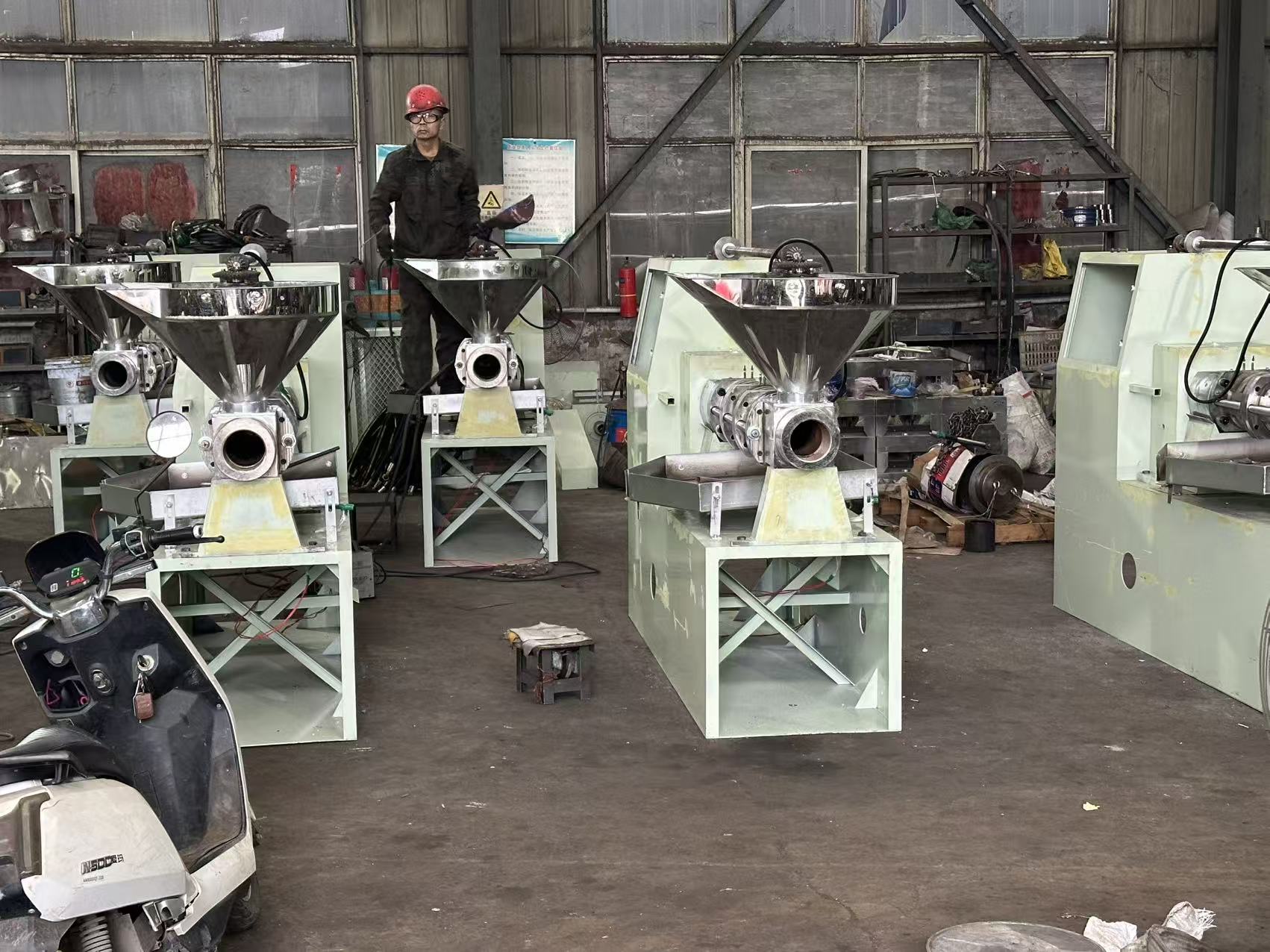 Modern manufacturing facility exterior view with industrial building, parking area, and professional signage